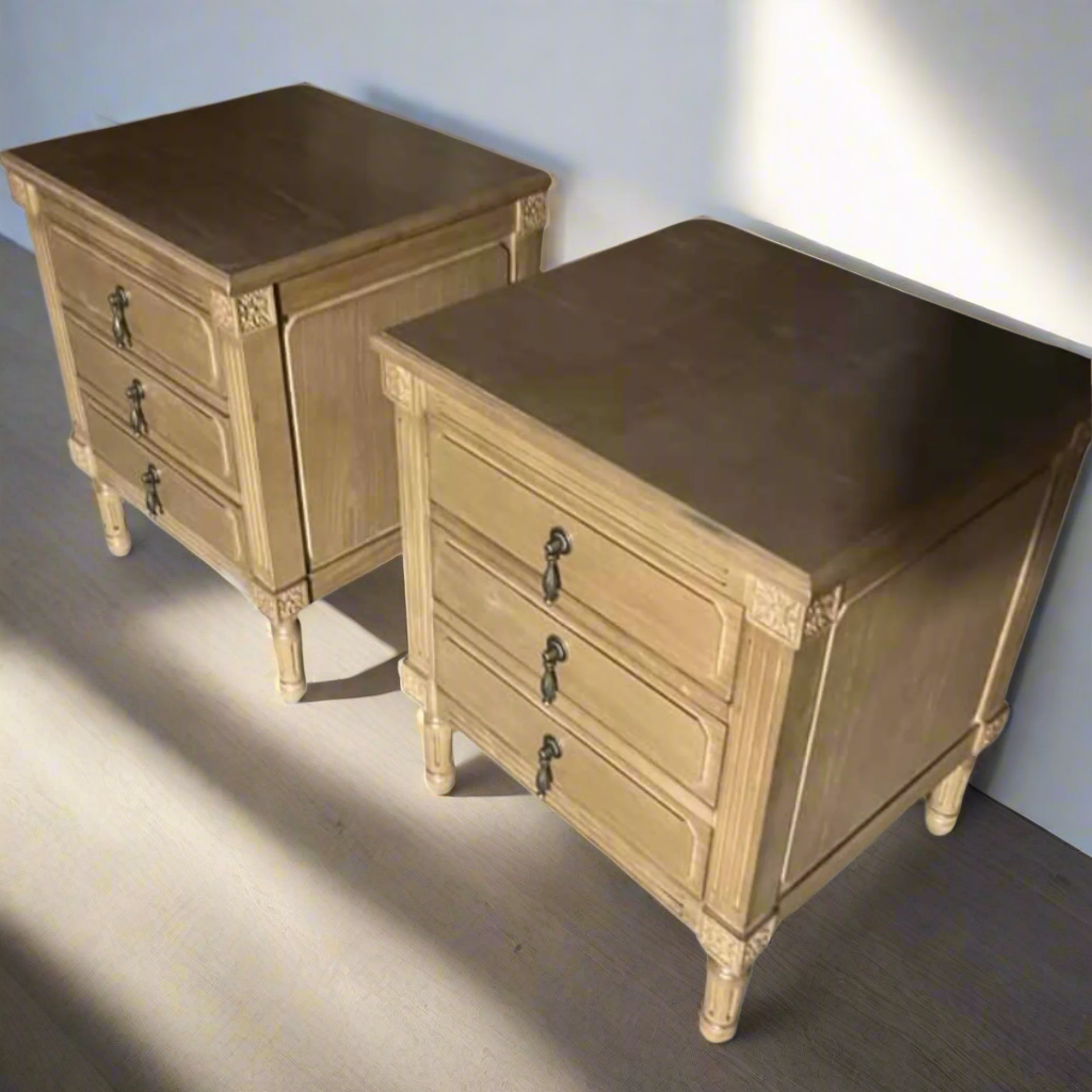 Two wooden nightstands with four drawers each on a white background